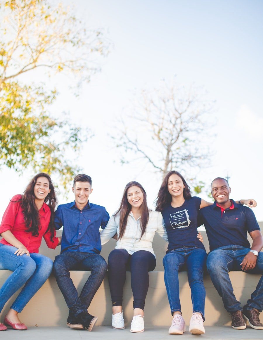 Happy diverse students celebrating together outdoors